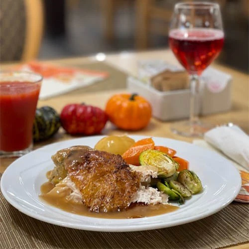 Thanksgiving plate of delicious looking food, including turkey, Brussels sprouts, stuffing, and more!