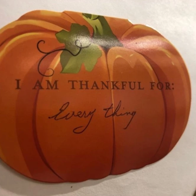 Pumpkin with text on it that says,