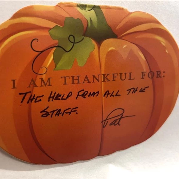 Pumpkin with text on it that says,