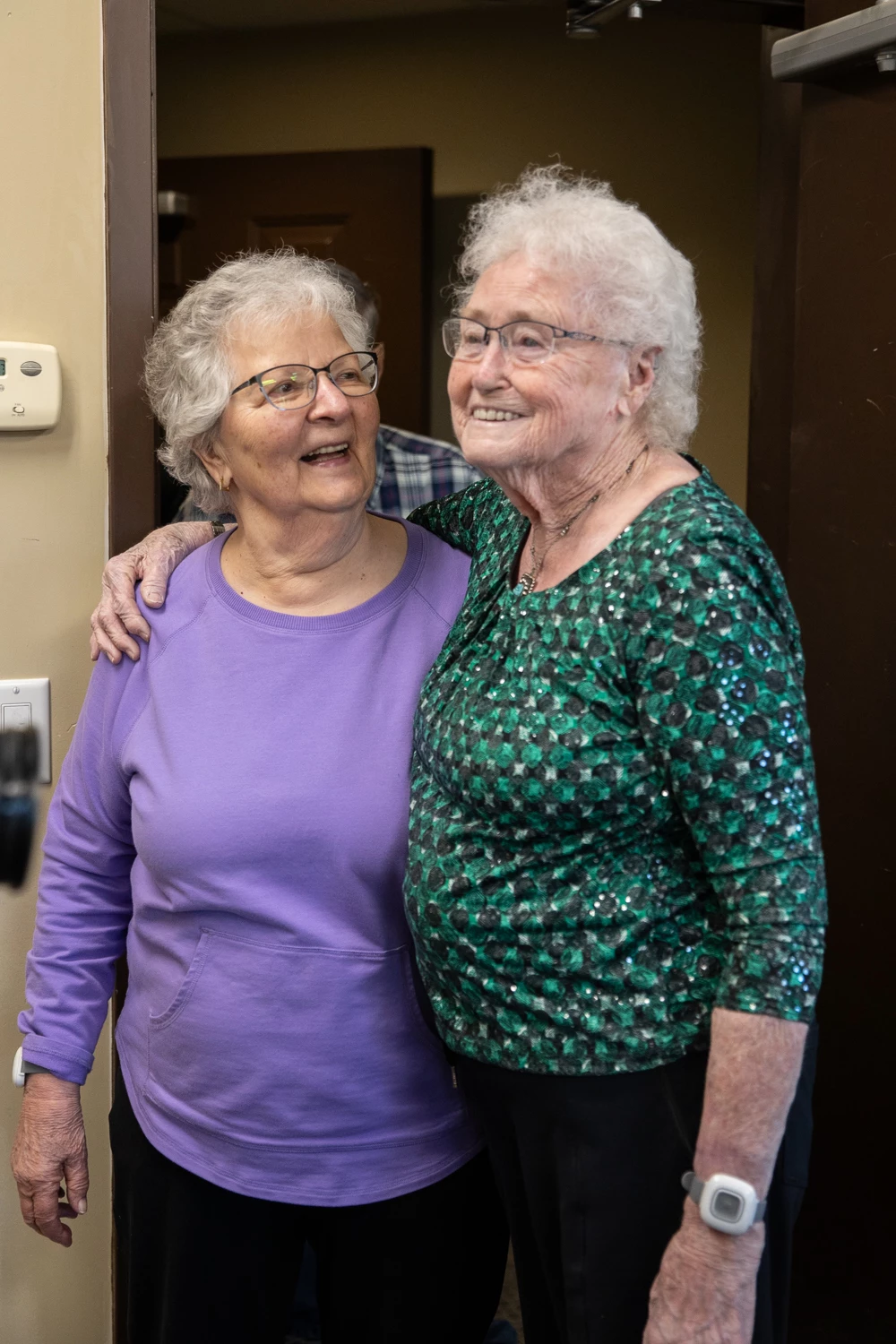 Nel and her friend holding shoulders and smiling
