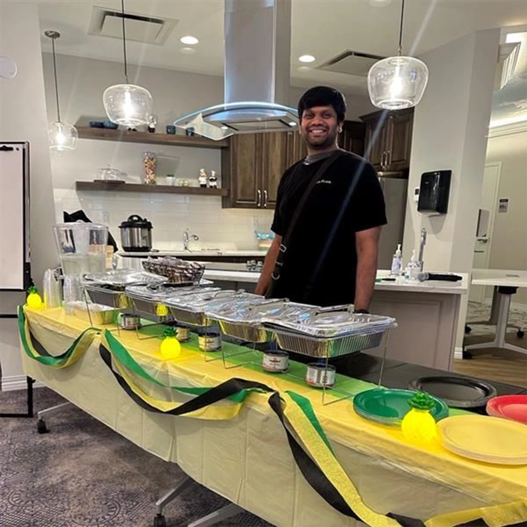 Aster Gardens chef standing in kitchen with food to be served