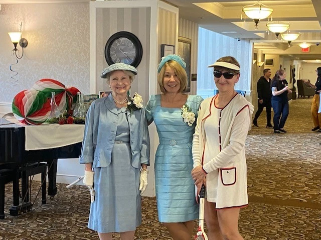 Three seniors posing in their vintage clothing