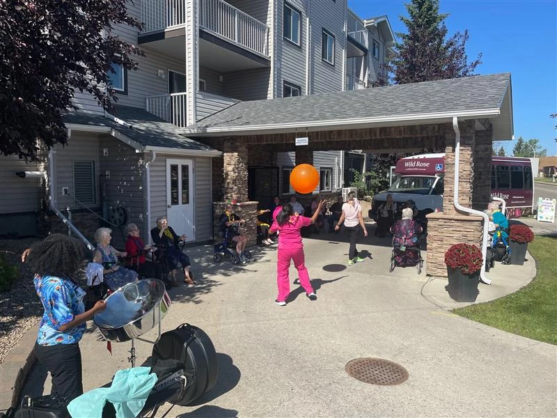 A group of people at Wild rose playing will an orange ball