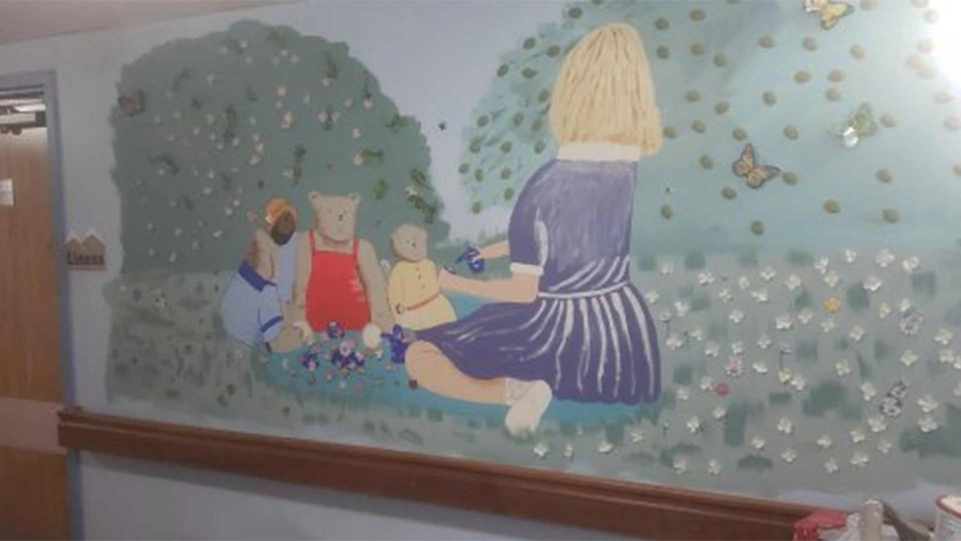 Girl playing with her toys mural on the wall