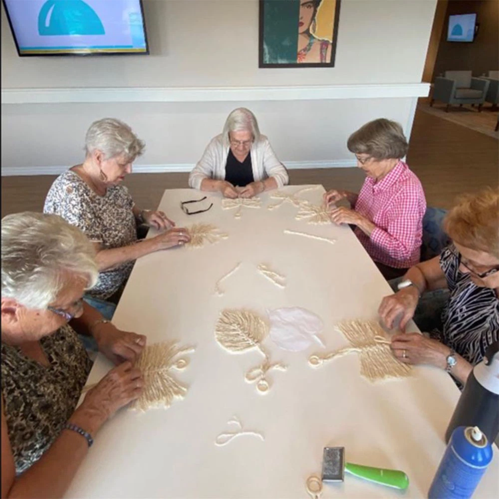 Senior ladies doing crafts on a craft table